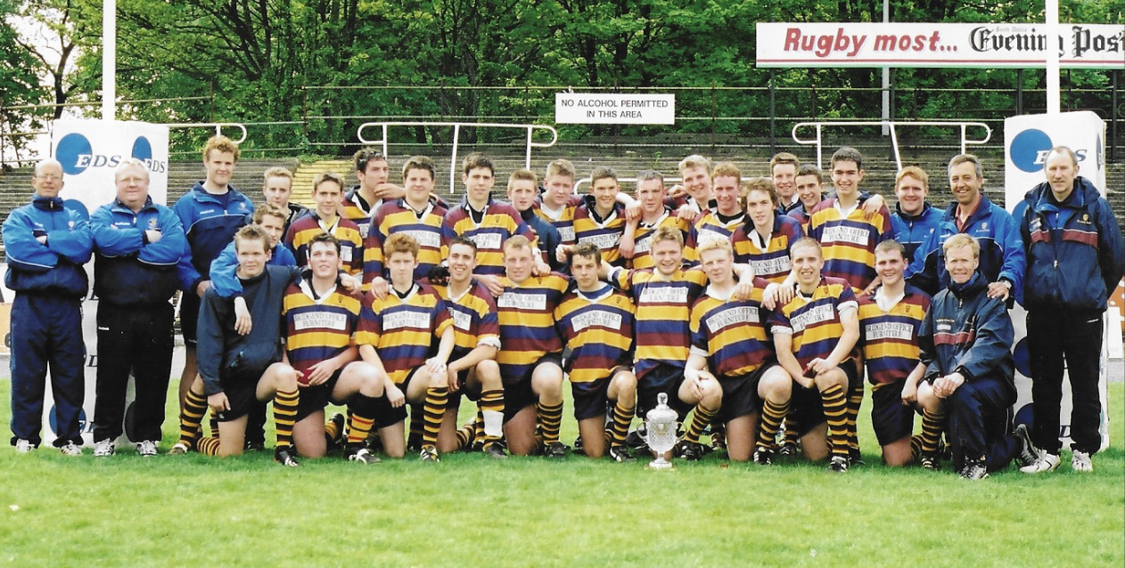 The 2003 squad and coaches with the Welsh Schools Cup at St Helen's